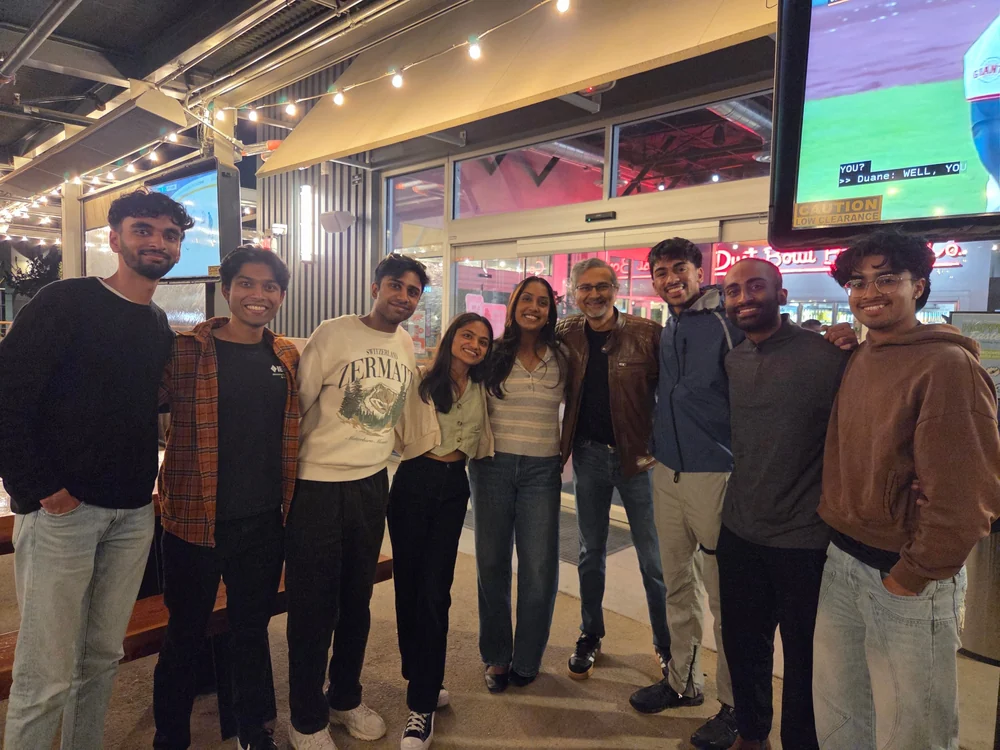 Night out with the team, everyone posing together outside